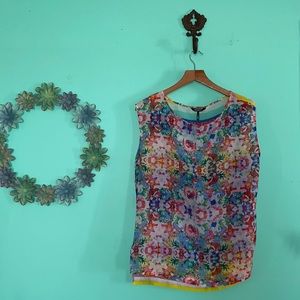 Daisy Fuentes- sheer, sleeveless, blouse.